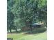 View of the house exterior surrounded by lush trees and a well-maintained lawn at 213 Whipporwill Way, Riverdale, GA 30274