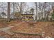 Charming backyard with a fire pit and steps leading to the lake, perfect for outdoor entertainment at 480 Mitchell Rd, Covington, GA 30014