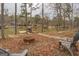This backyard has mature trees, a firepit, and a waterfront view at 480 Mitchell Rd, Covington, GA 30014