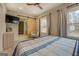 Cozy bedroom with a ceiling fan, barn door to bathroom, and neutral décor at 480 Mitchell Rd, Covington, GA 30014