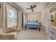 Bright bedroom features a ceiling fan and two large windows with curtains at 480 Mitchell Rd, Covington, GA 30014