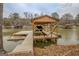 Wooden covered boat dock featuring a boat lift, providing easy access for boating and water activities at 480 Mitchell Rd, Covington, GA 30014