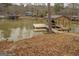 Picturesque covered boat dock with boat, offering direct lake access and recreational opportunities at 480 Mitchell Rd, Covington, GA 30014
