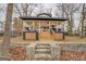 Charming exterior of home featuring a cozy front porch with outdoor seating, stairway to the front door, and wooded surroundings at 480 Mitchell Rd, Covington, GA 30014