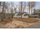 White home exterior surrounded by mature trees and a yard perfect for outdoor activities at 480 Mitchell Rd, Covington, GA 30014