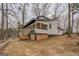Stylish lake house with a spacious porch and outdoor stairs, showcasing a seamless blend of indoor/outdoor living at 480 Mitchell Rd, Covington, GA 30014
