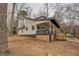 Charming white exterior with a large covered porch perfect for relaxing and entertaining at 480 Mitchell Rd, Covington, GA 30014