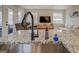 Kitchen island with stainless steel sink and open layout to the living room at 480 Mitchell Rd, Covington, GA 30014
