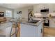 Open kitchen with granite island and barstool seating flowing into the comfortable living space at 480 Mitchell Rd, Covington, GA 30014