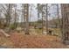 Serene lake view with mature trees, a boat dock, and neighborhood houses across the water at 480 Mitchell Rd, Covington, GA 30014