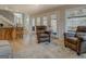 Open-concept living room with comfortable seating, bar-stool seating, light wood flooring, and a glass door to the exterior at 480 Mitchell Rd, Covington, GA 30014