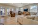 Bright living room with comfortable seating, TV, windows overlooking the trees and a sliding glass door to a deck at 480 Mitchell Rd, Covington, GA 30014