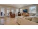 Bright living room with comfortable seating, TV, windows overlooking the trees and a sliding glass door to a deck at 480 Mitchell Rd, Covington, GA 30014