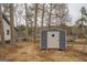 Exterior view of a shed, offering additional storage with lake views in the background at 480 Mitchell Rd, Covington, GA 30014