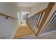 Modern staircase with wooden treads and black metal railings leading to a lower level at 480 Mitchell Rd, Covington, GA 30014