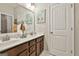 Bathroom with double sinks, a large mirror, and white cabinets at 135 Adam Ridge Ln, Fayetteville, GA 30214