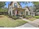 Lovely home with inviting front porch, mature landscaping and charming details, perfect for relaxing outdoors at 135 Adam Ridge Ln, Fayetteville, GA 30214