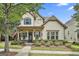 Charming two-story home featuring blue shutters, a welcoming front porch, and professional landscaping at 135 Adam Ridge Ln, Fayetteville, GA 30214