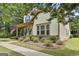Landscaped front of a home, featuring a sidewalk, lawn, and mature trees, offering great curb appeal at 135 Adam Ridge Ln, Fayetteville, GA 30214