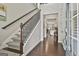 Bright foyer with hardwood floors, staircase, and a view into an open-concept kitchen at 135 Adam Ridge Ln, Fayetteville, GA 30214