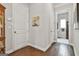 Inviting hallway with hardwood floors, neutral walls, and tasteful decor, leading to various rooms in the home at 135 Adam Ridge Ln, Fayetteville, GA 30214