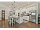 Well-lit kitchen featuring stainless steel appliances, granite counters and a spacious island at 135 Adam Ridge Ln, Fayetteville, GA 30214