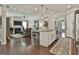 Open kitchen showcasing an island that flows into a living room with fireplace at 135 Adam Ridge Ln, Fayetteville, GA 30214
