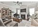 Beautifully furnished living room with fireplace, grand piano, and comfortable seating arrangement creating a cozy atmosphere at 135 Adam Ridge Ln, Fayetteville, GA 30214