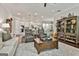 Open-concept living area showcases hardwood floors, modern furniture, and seamless flow to the kitchen and dining area at 135 Adam Ridge Ln, Fayetteville, GA 30214