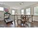 Bright loft features hardwood floors, an American flag, a treadmill, and a dining area with a chandelier at 135 Adam Ridge Ln, Fayetteville, GA 30214