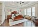 Spacious main bedroom with tray ceiling, dark wood furniture, and lots of natural light at 135 Adam Ridge Ln, Fayetteville, GA 30214
