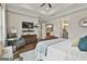 Beautiful main bedroom with tray ceilings, accent chair, and en suite bathroom at 135 Adam Ridge Ln, Fayetteville, GA 30214