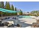 Resort-style community pool with lounge chairs and shade canopies for relaxation and enjoyment at 135 Adam Ridge Ln, Fayetteville, GA 30214