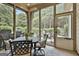 Relaxing screened in sunroom offers outdoor views and dining at 135 Adam Ridge Ln, Fayetteville, GA 30214