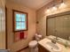 Well-lit bathroom with a single vanity, toilet, and a window for natural light at 4402 Auburn Hills Drive, Stone Mountain, GA 30083