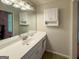 Bathroom features a single sink vanity with white cabinetry and a large mirror at 4402 Auburn Hills Drive, Stone Mountain, GA 30083
