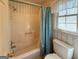 Full bathroom includes a tub and shower combination with floral wallpaper and a window at 4402 Auburn Hills Drive, Stone Mountain, GA 30083