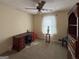 Bedroom with wooden desk, bookcase, neutral walls and carpet and a ceiling fan at 4402 Auburn Hills Drive, Stone Mountain, GA 30083