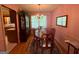 Elegant dining room with classic wooden furniture, chandelier, and a window for natural light at 4402 Auburn Hills Drive, Stone Mountain, GA 30083