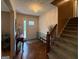 Inviting foyer featuring hardwood floors, elegant lighting, and a staircase leading to the upper level at 4402 Auburn Hills Drive, Stone Mountain, GA 30083