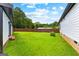 Spacious backyard featuring a lush green lawn and a privacy fence with trees in the background at 80 David Rd, Hampton, GA 30228