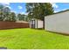 Backyard showing the green lawn, wood fence, and shed perfect for extra storage space at 80 David Rd, Hampton, GA 30228