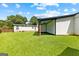Backyard with a well-maintained lawn, a covered patio area, and storage unit for all your belongings at 80 David Rd, Hampton, GA 30228