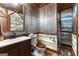 Cozy bathroom with a wooden toilet seat, wood grain vanity, and unique combination metal and wooden planks at 80 David Rd, Hampton, GA 30228