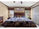 Cozy bedroom featuring a wooden headboard, a quilt bedding set, and natural light at 80 David Rd, Hampton, GA 30228