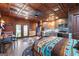 Bedroom with a partial kitchen, dining table, and cowhide rug beneath a ceiling of copper-colored ceiling tiles at 80 David Rd, Hampton, GA 30228