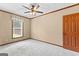 Bedroom with neutral carpet, a ceiling fan, and a sunlit window at 80 David Rd, Hampton, GA 30228