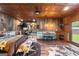 Spacious bedroom with rustic metal walls, copper colored ceiling tiles, and an eat-in dining table at 80 David Rd, Hampton, GA 30228