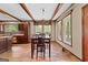 A dining room featuring wood floors, exposed beams, and large windows at 80 David Rd, Hampton, GA 30228
