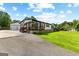 Charming single Gathering home with a well-manicured lawn, covered porch and detached garage at 80 David Rd, Hampton, GA 30228